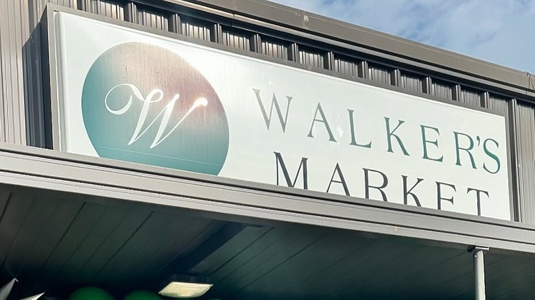 Specialty food store entrance framed by green balloons