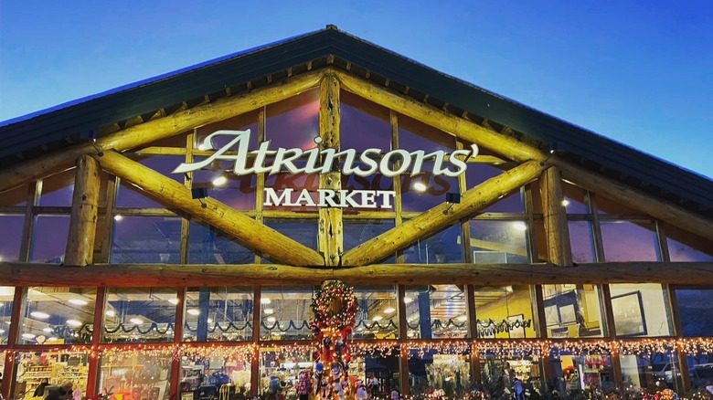 Lodge-like building decorated with holiday lights and a sign that reads "Atkinsons' Market"