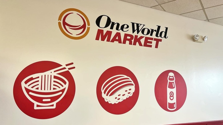Red icons on white wall and "One World Market" logo