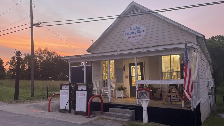 Small white house with front porch and sign that reads "Newby Country Store"
