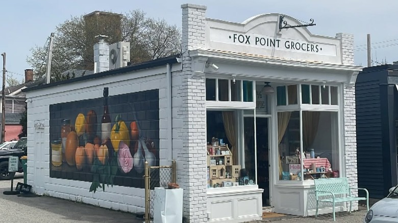 White brick building with a sign that reads "Fox Point Grocers"