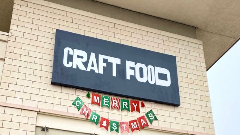 Black sign with white letters that read "Craft Food"