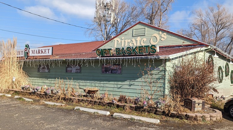 Green paneled house with a sign that reads "Pirate O's"