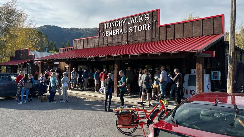 People gathered in the parking lot of Hungry Jack's General Store