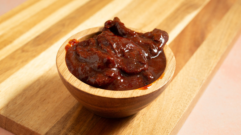 Chipotles in adobo in a wooden bowl