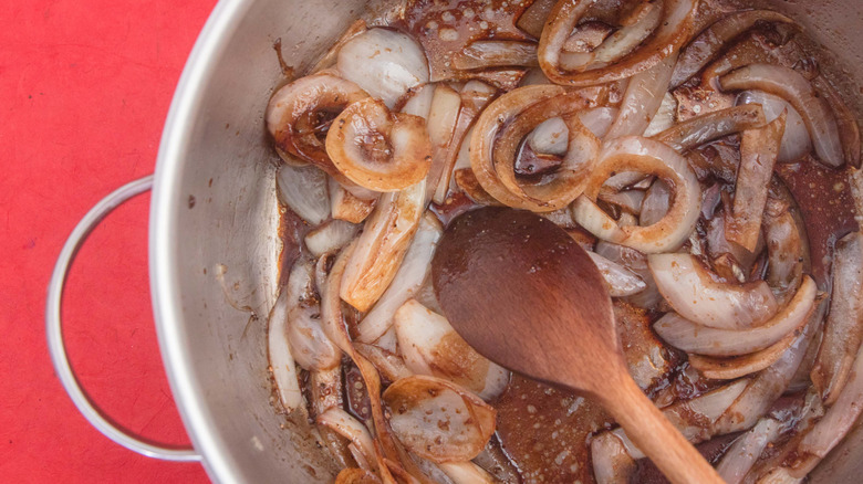 Pot of caramelized onions with wooden spoon