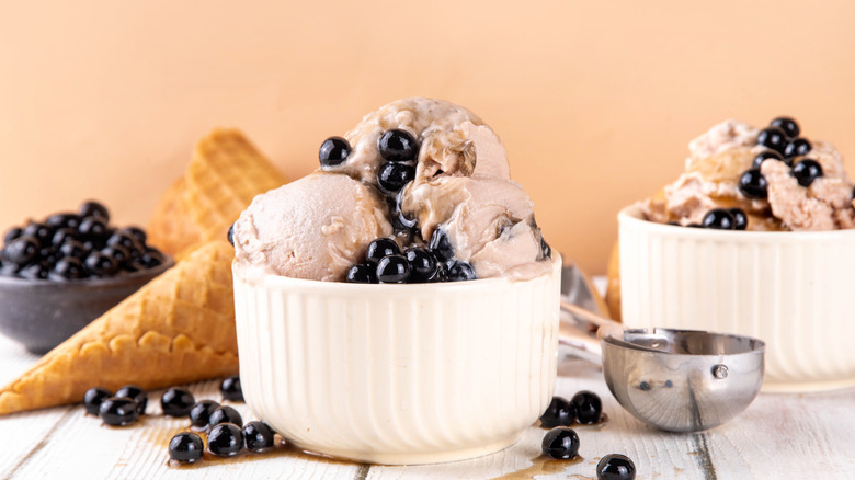 A bowl of coffee ice cream with boba pearls