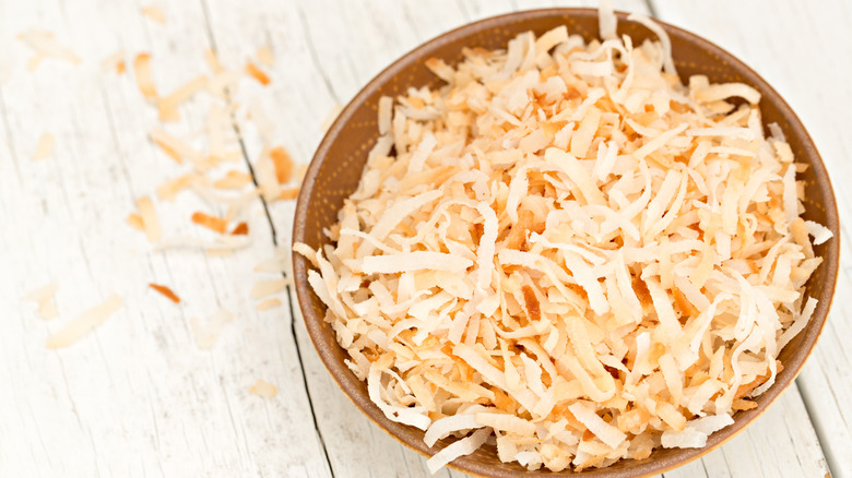 Toasted coconut in a brown bowl