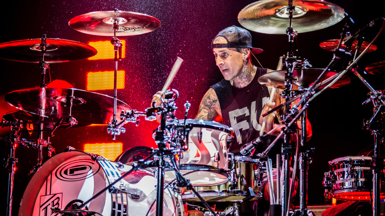 Travis Barker playing drums on stage