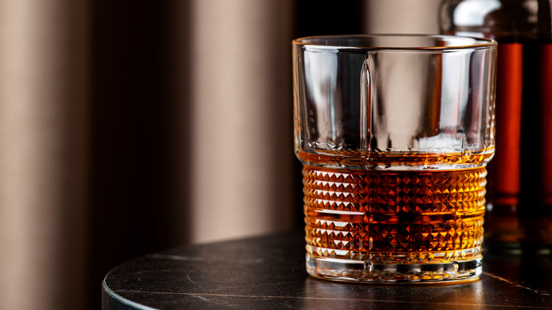 Glass of bourbon on a table