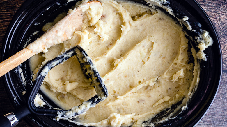 Overhead view of mashed potatoes inside a slow cooker