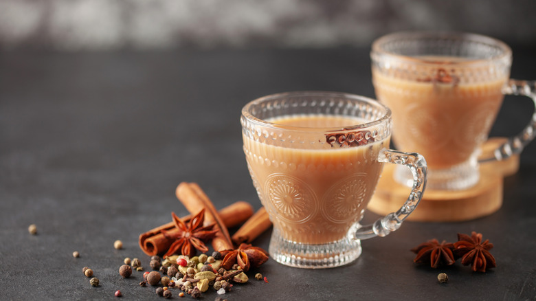 Two glass mugs of chai tea with spices