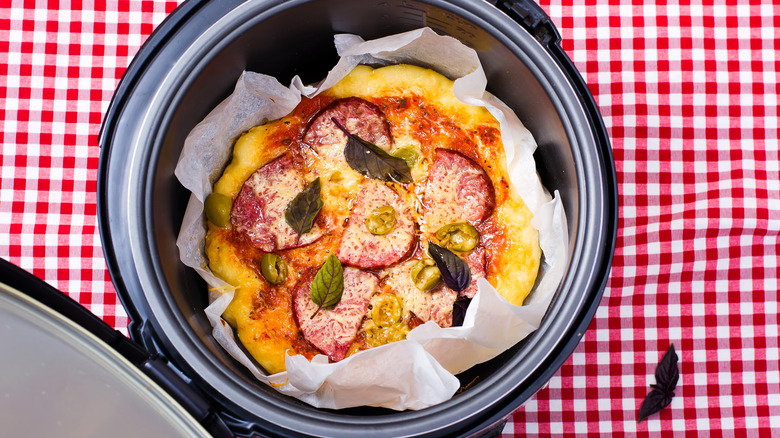 Overhead view of open crock pot with pizza inside