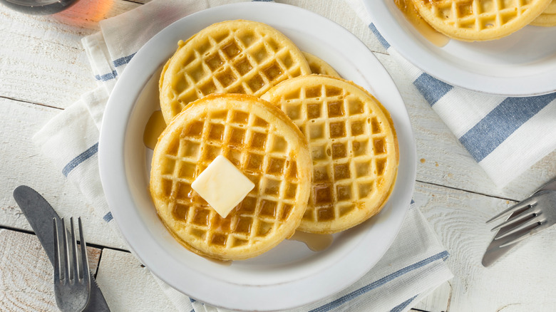 Waffles with butter on a white plate