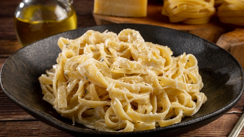 A plate filled with fettuccine Alfredo pasta.
