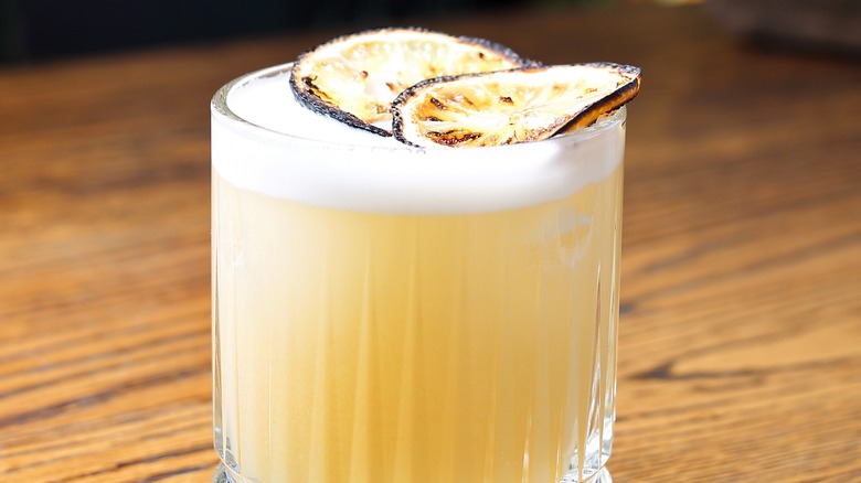 whiskey sour garnished with lemon