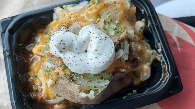 Wendy's baked potato topped with cheese, chili, sour cream, and pepper