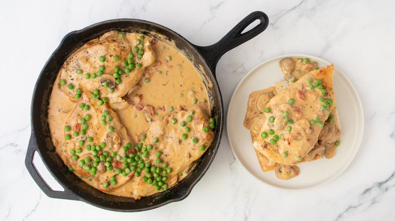 A plated portion of chicken a la king and a skillet filled with the remaining portions