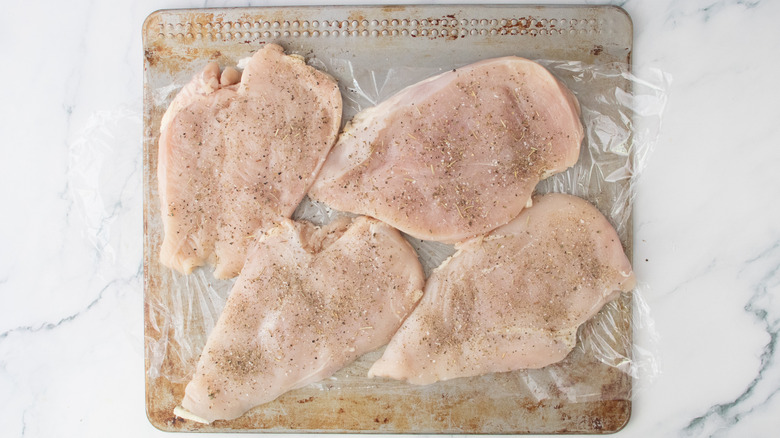 Pounded chicken cutlets sprinkled with seasoning