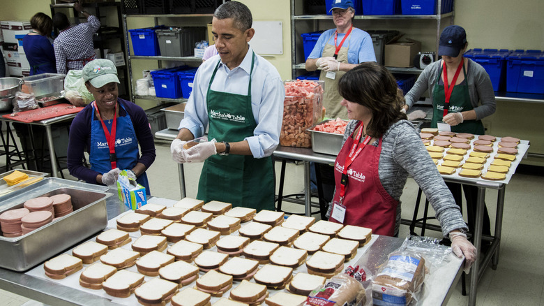 Barack Obama in kitchen with workers making bologna and cheese sandwiches for furloughed employees