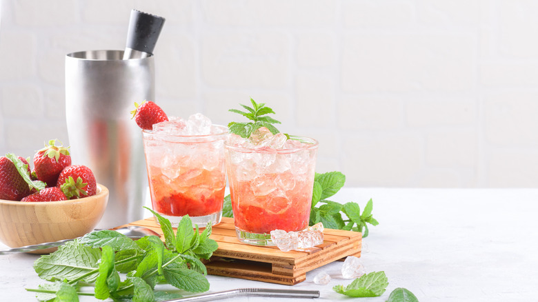 strawberry daiquiris with muddler and mint