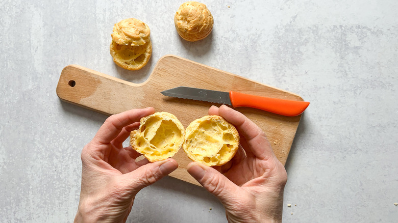 Sliced gruyere gougerès on cutting board