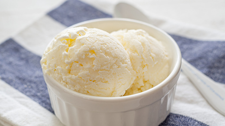 Vanilla ice cream in a white ramekin.