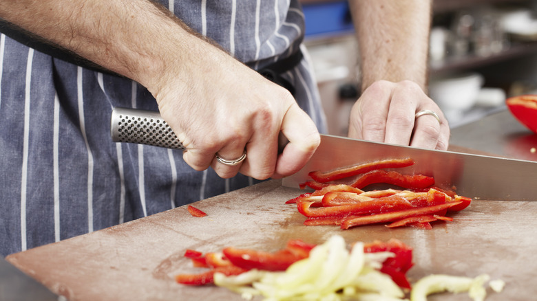 Red bell peppers being sliced