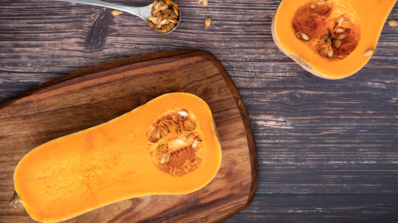 Halved butternut squash on cutting board