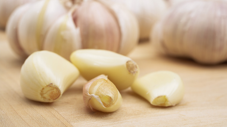 Peeled garlic cloves on board