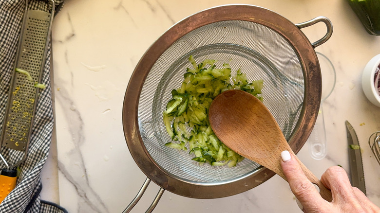 draining cucumber in colander