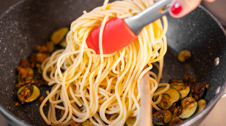 pasta going into pan 