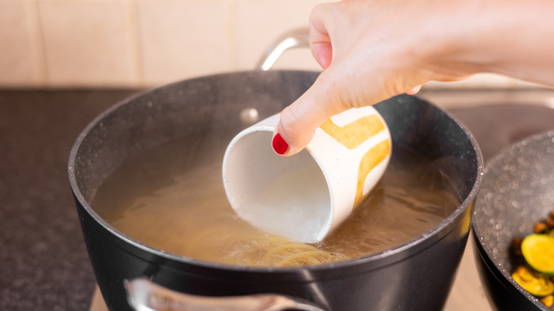 cup reserving pasta water 