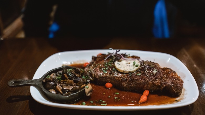 A serving of steak in a plate at a steakhouse restaurant