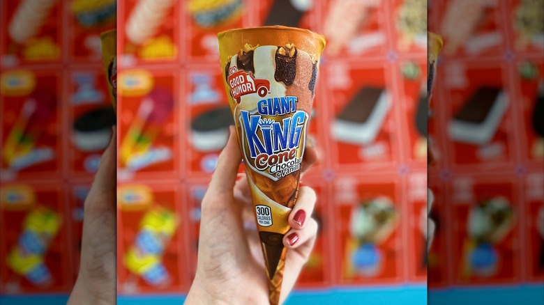 Giant King Cone in hand with ice cream truck background