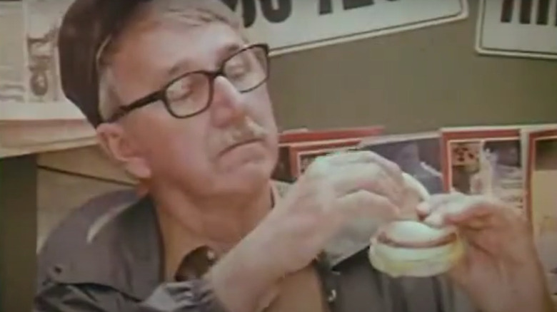 Man looking inside his Egg McMuffin