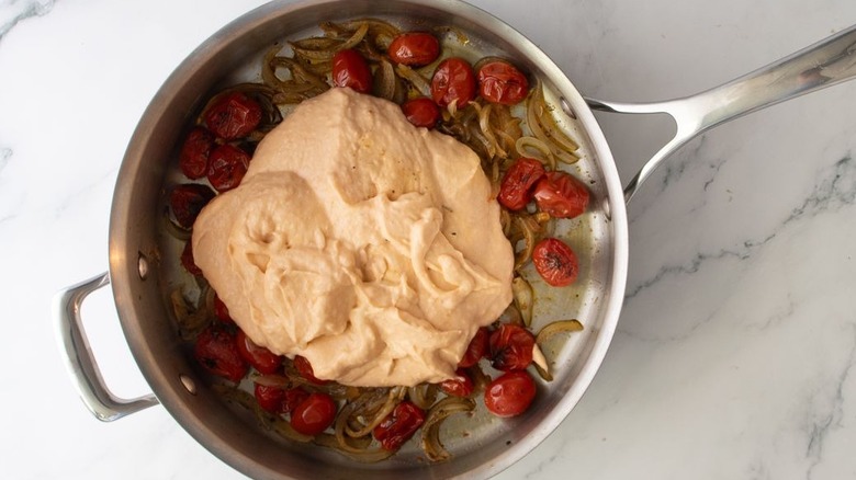 Roasted veggies and lobster bisque in skillet