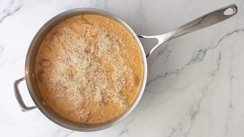 Lobster bisque and Parmesan cheese in skillet