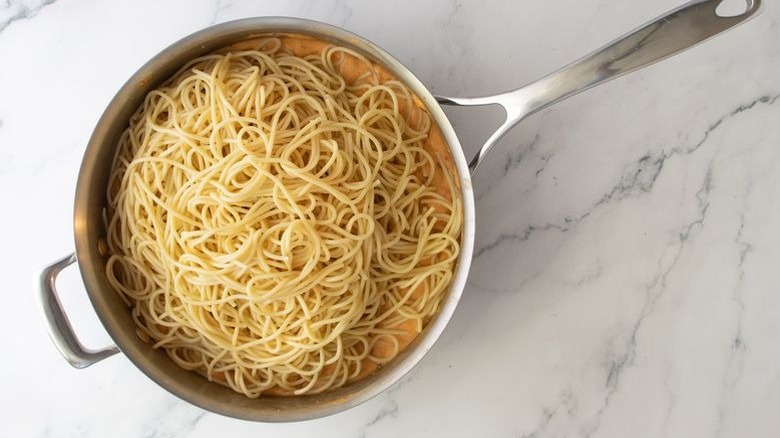 Pile of spaghetti sitting in skillet