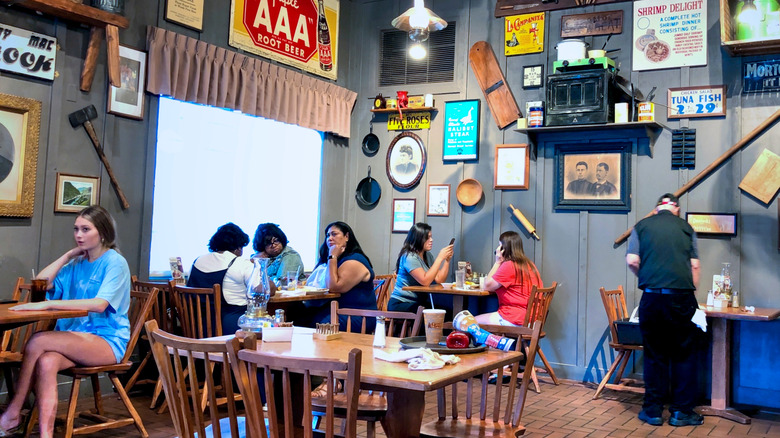 People sitting at tables inside a Cracker Barrel restaurant