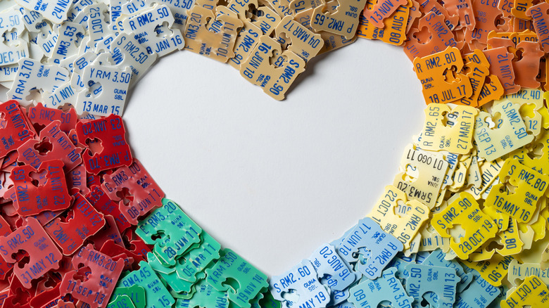 A batch of bread tags arranged by color, with an empty heart shape in the center.