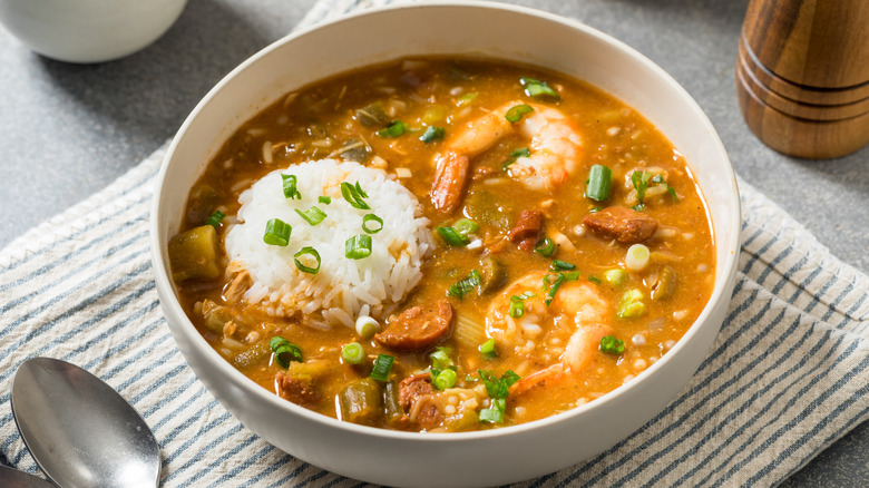 A bowl of gumbo with shrimp and rice.