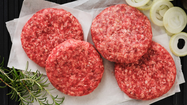 Raw burger patties on butcher paper
