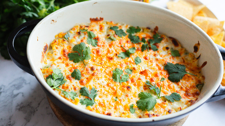 Cheesy corn dip with cilantro and chips