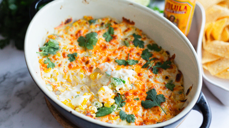 Corn dip with chips and bite taken out
