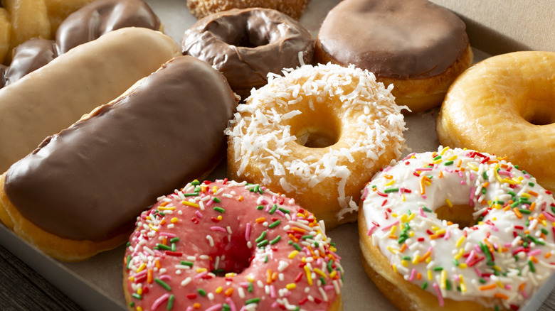 An assortment of donuts with frosting and sprinkles