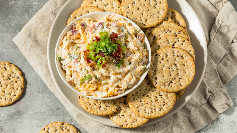 blended dip in white bowl with crackers