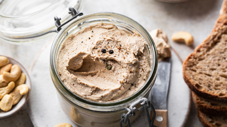pate in glass jar with spread knife
