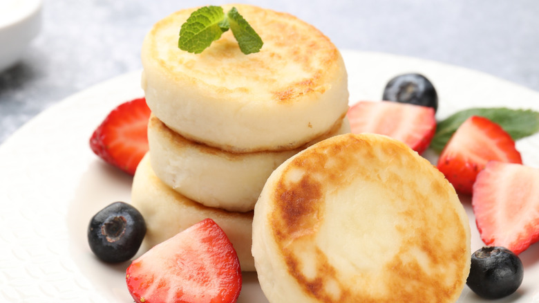 Fluffy cottage cheese pancakes with fresh berries and mint.