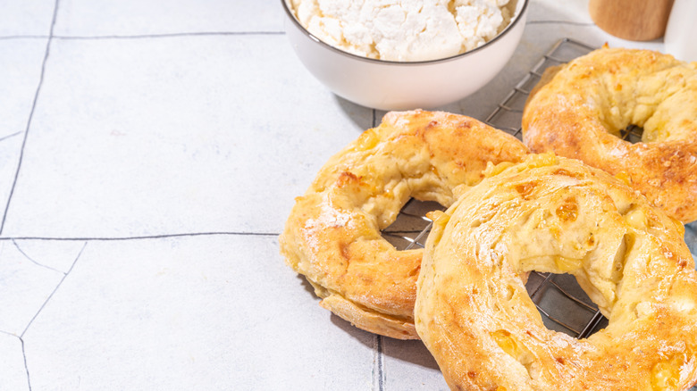 Toasty cottage cheese bagels on a white tablecloth.